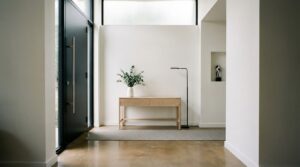 Minimalist front entrance with sleek door, neutral tones and clean lighting.